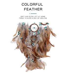Detailed shot of bohemian dream catcher with soft brown feathers and blue beads