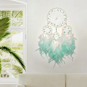 Close-up detail of a four-hoop dream catcher featuring mint green and white gradient feathers
