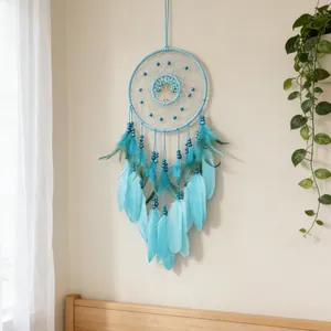 Handmade turquoise Tree of Life dreamcatcher with blue feathers for boho wall hanging decor.