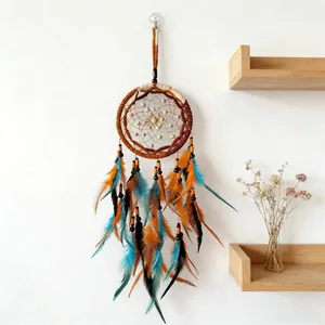 Detailed view of handmade dreamcatcher with vibrant orange and blue feathers