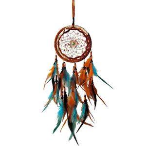 Detailed macro view of a handmade dreamcatcher featuring orange and blue feathers