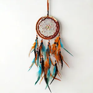 Detailed view of a handmade dreamcatcher with colorful feathers and wooden beads decoration.