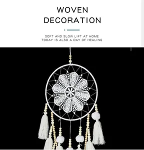 Detailed view of handcrafted Nordic dream catcher with white lace and tassels