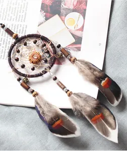 Vintage Indian style car dreamcatcher hanging with colorful feathers and wooden beads