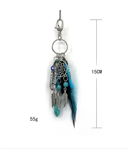 Detailed view of Indian dreamcatcher keychain featuring blue feathers and turquoise stone detail