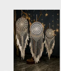 Three sizes of handmade white crochet dreamcatchers with feathers for home decor