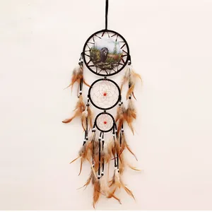 Handmade vintage Indian style dreamcatcher with bear nature scene and brown feathers