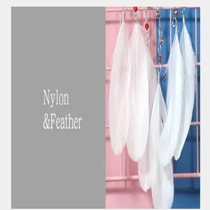 Close-up macro detail of soft white feathers and nylon materials for dreamcatcher decor