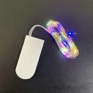 Multi-colored LED copper wire fairy lights with white battery box on black background