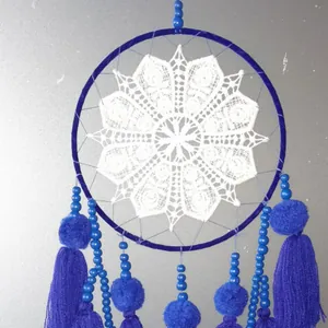 Handmade blue dreamcatcher wall hanging with white lace petal design and tassels
