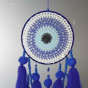 Handmade evil eye dreamcatcher with blue tassels and wooden beads for home wall decor