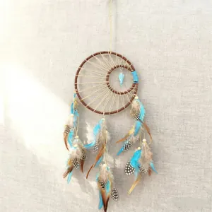 Vintage Indian style dreamcatcher with blue feathers for home wall hanging art decor.