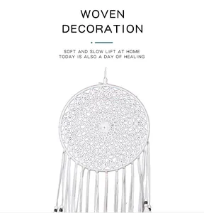 Elegant white woven dreamcatcher featuring a delicate mandala pattern and tassels