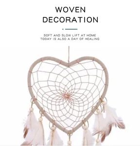 Handmade white heart-shaped dreamcatcher with feathers for home or car wall hanging decor.