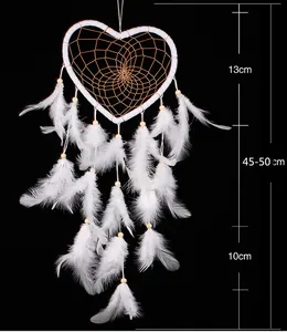 Close-up of heart-shaped white dreamcatcher with dimensions showing soft feathers and bead details