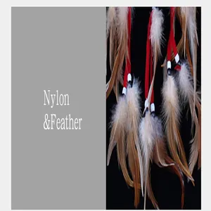 Macro detail of natural brown feathers and red nylon thread of the dreamcatcher