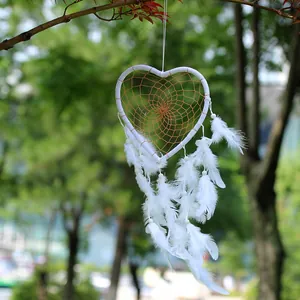 Handmade white heart-shaped dream catcher with feathers for home or car decoration