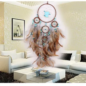 Handcrafted bohemian dreamcatcher with brown feathers and turquoise stone beads!