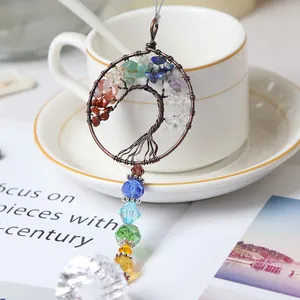 Close-up of tree of life suncatcher with natural crushed stones and crystal prism