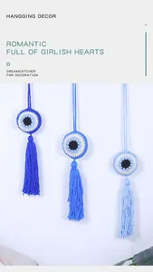 Detailed view of handmade crochet evil eye hangings in three distinct shades of blue.