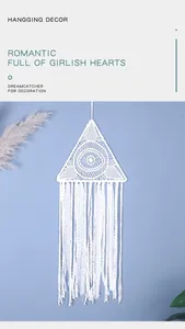 Close-up of white hand-woven triangular dreamcatcher with elegant lace tassels
