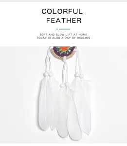 Detailed view of the white feathers and colorful crochet on a minimalist dreamcatcher