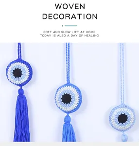 Detailed macro view of handmade crochet evil eye pendants featuring elegant blue tassels