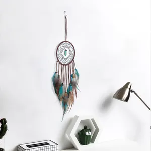 Handmade dreamcatcher with turquoise stone and colorful feathers for creative wall decor