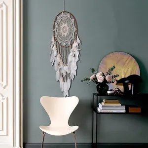 Handmade boho lace dreamcatcher wall hanging with white feathers for Nordic home decor.