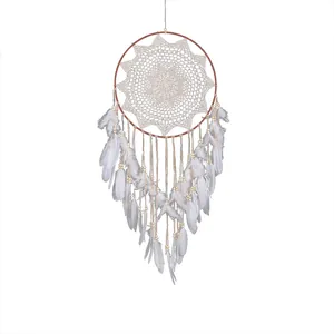 Nordic style handmade dream catcher with white feathers and lace crochet detail