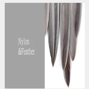 Detail of a retro dreamcatcher featuring soft grey feathers and durable nylon cord