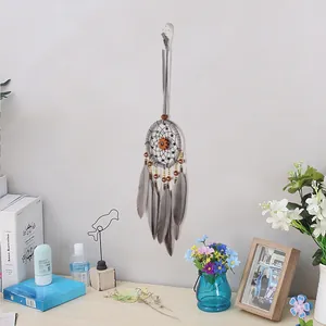 Vintage dreamcatcher with pumpkin gear center and grey feathers for home wall decor