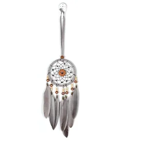 Vintage grey dreamcatcher wall hanging with natural feathers and pumpkin gear centerpiece