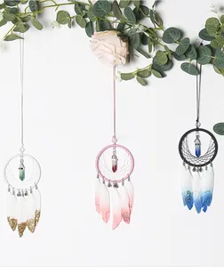 Three handmade dreamcatcher wall hangings with feathers and crystals for boho decor.