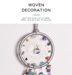 Close-up of handmade dreamcatcher with colorful crushed stones and center crystal pendant