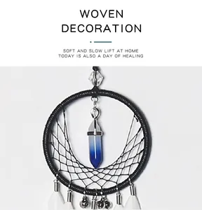 Detailed view of handmade woven dreamcatcher featuring a blue crystal and white feathers