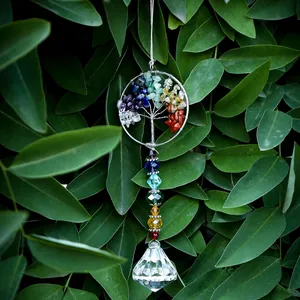 Tree of Life suncatcher with natural stone chips and crystal prism hanging on green leaves