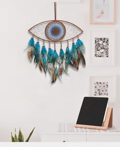 Detail view of a blue Evil Eye dreamcatcher with feathers hanging in a modern room