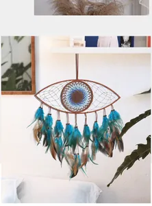 Detailed close-up of a blue evil eye dreamcatcher wall hanging with turquoise feathers decoration