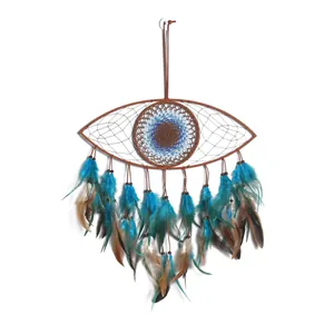 Blue evil eye dreamcatcher wall hanging decor with feathers and beads on white background.
