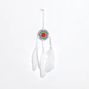 Small handmade dreamcatcher pendant with white feathers and floral heart center