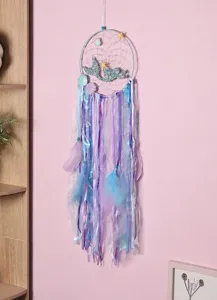 Detail of mermaid theme dream catcher with purple and blue ribbons on pink wall