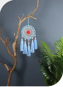 Blue handmade Nordic dreamcatcher with colorful beads and tassels on decorative branch