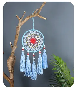 Detail view of light blue Nordic dreamcatcher with colorful weave and long tassels.