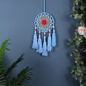 Nordic style light blue dreamcatcher wall hanging with colorful weaving and tassels.