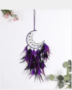 Close-up detail of purple feathers and beads on handmade crescent moon dreamcatcher