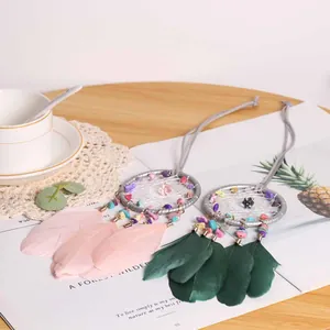 Handmade woven dreamcatcher pendant with crushed natural stones and soft colorful feathers