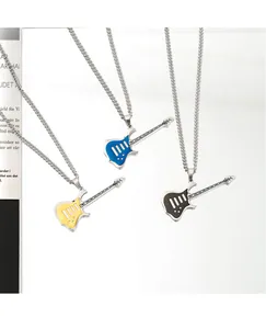 Close-up of three punk rock guitar necklaces in yellow, blue, and black enamel finish.
