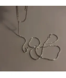 Macro view of a shimmering silver sterling chain with sparkling texture and light reflection