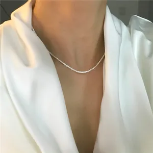Close-up view of a sparkling silver star chain necklace elegantly worn on a woman's neck